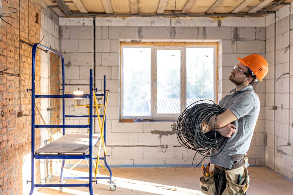 electrician preparing to install wiring in a residential space