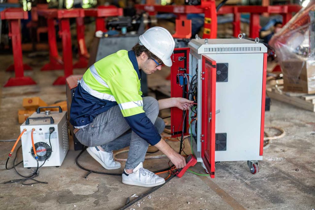 Technician installing a generator plug for electrical construction services.
